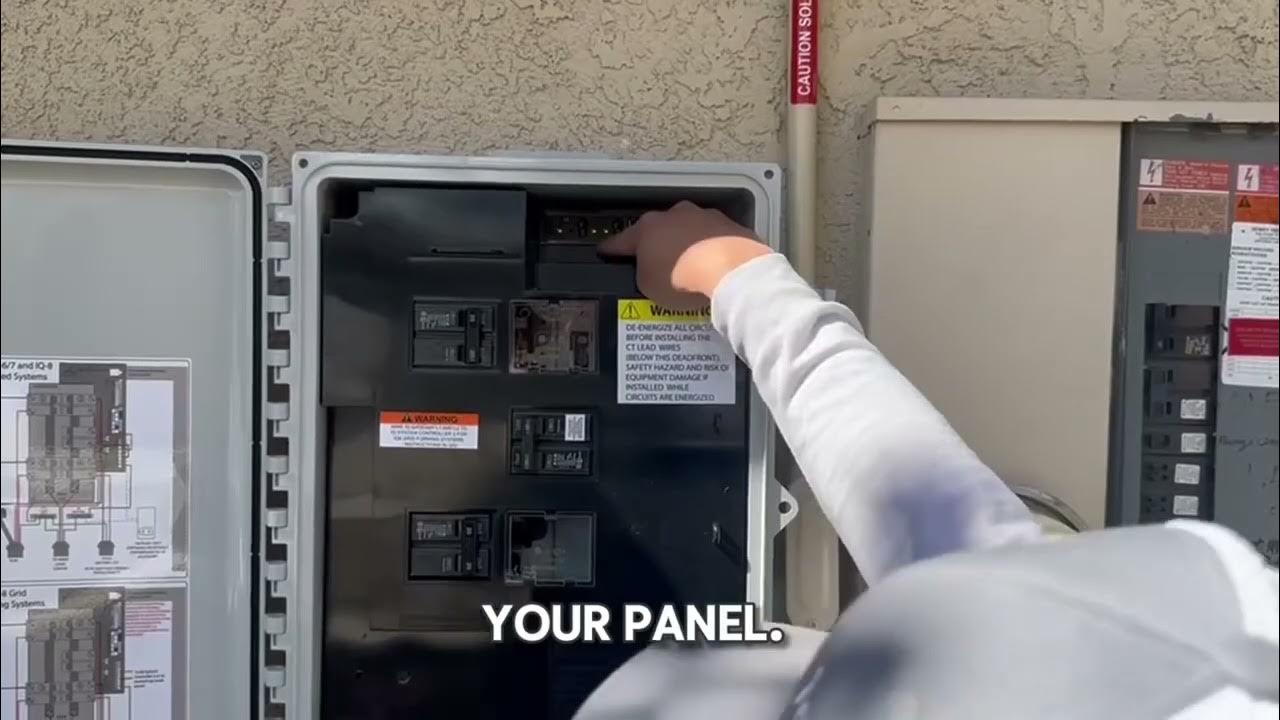 Person reaching into open outdoor electrical panel